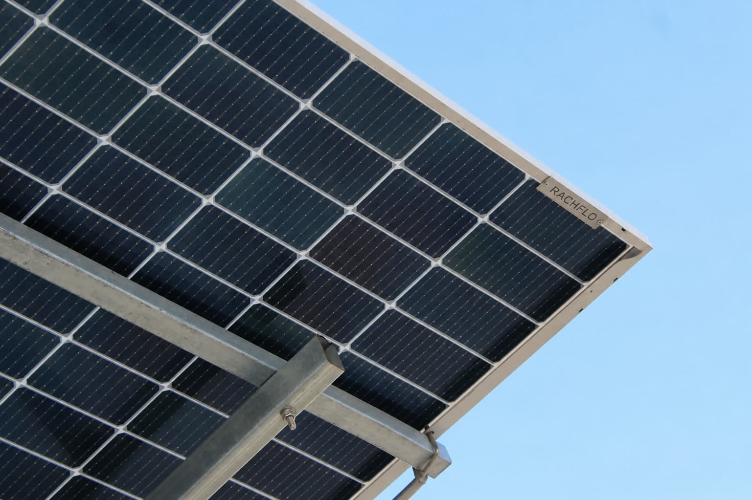 Solar module frame and mounting rail against a clear sky